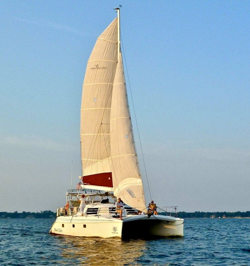 Now and Zen 42ft Manta catamaran under full sail on the St Johns River Jacksonville Florida