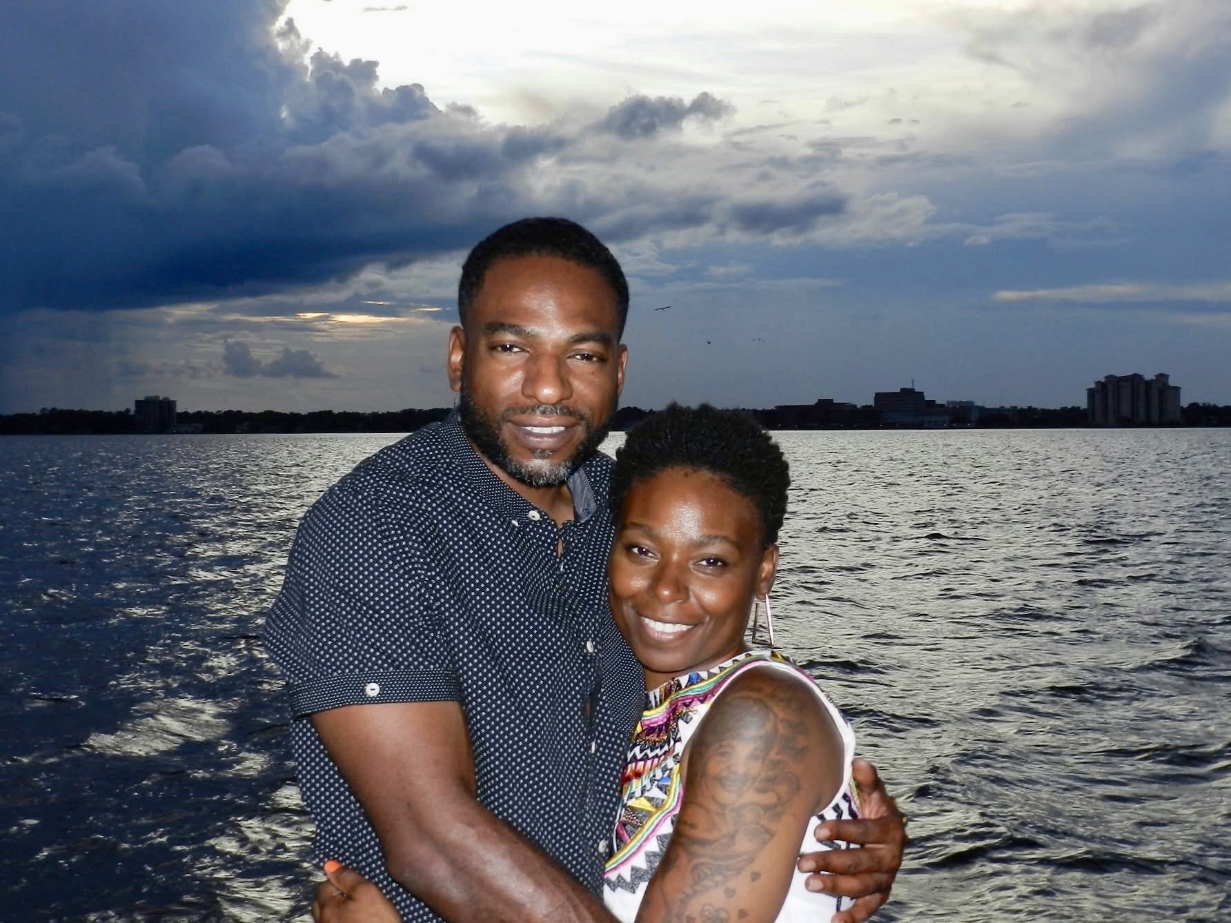 Couple embracing on the deck of Now and Zen catamaran on the St Johns River Jacksonville
